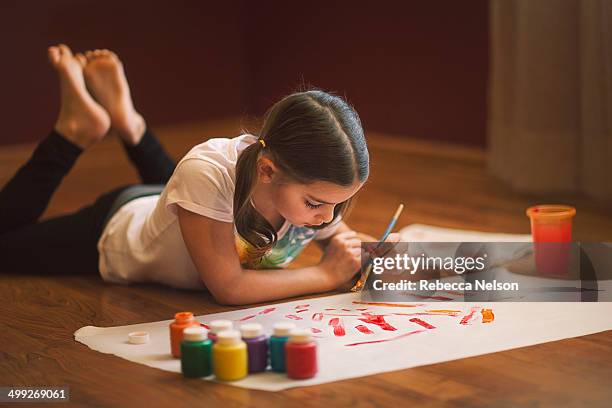 girl using paints - child painting stock-fotos und bilder