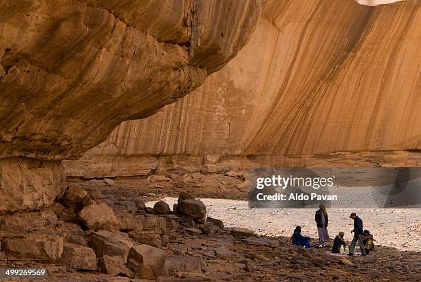 tuareg under rock formations, akakus desert - native african ethnicity stock pictures, royalty-free photos & images