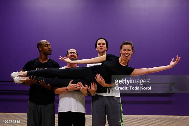 Cast members Travis Knights Ryan Foley and Danny Nielsen lift Allison Foley while rehearsing for the Big Band Tap Revue in Toronto, Ontario.