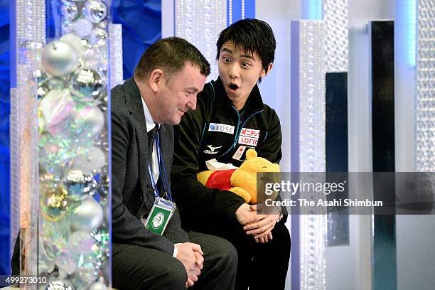 Yuzuru Hanyu of Japan talks with his coach Brian Orser at the kiss and cry after competing in the Men's Free Skating during day two of the NHK Trophy...