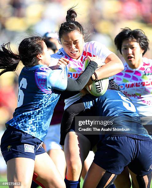Ano Kuwai of Japan is tackled during the World Sevens Asia Olympic Qualification match between Japan and Guam at Prince Chichibu Stadium on November...