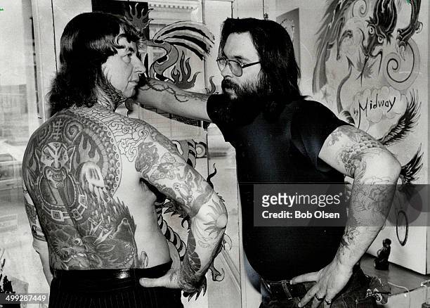 Tattoo man: No; this duo isn't our City Page team of Bob Pomerantz and Jane Widerman; it's Toronto's own illustrated man Bill Freeman with the broad...