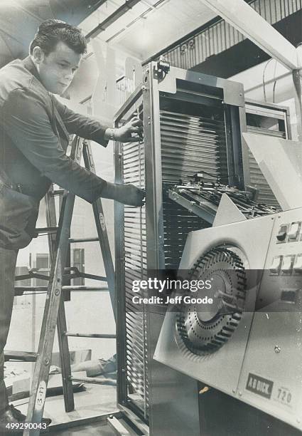 Setting up a $6;000 sorting machine for the computer show is Bob McLean; service representative for A.B. Dick Canada Ltd.The slanting bins can sort...