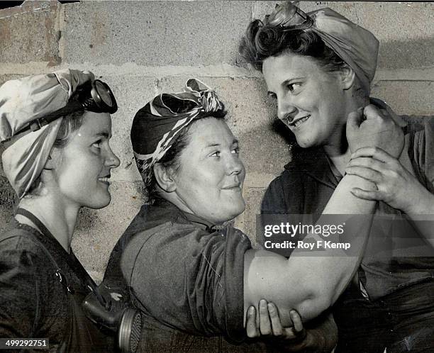 That's all muscle on the arm of Mrs. Robert Wright; 235-pound sandblaster at John Inglis Co. In Toronto. Mrs. Mollie Robinson feels the muscle; while...