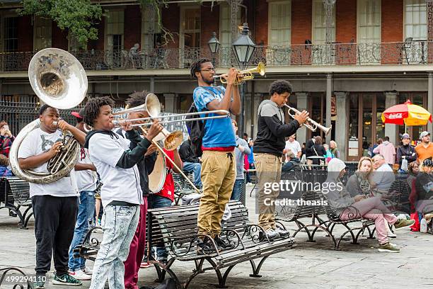 jazz musicians busk in jackson square, new orleans - new orleans band stock pictures, royalty-free photos & images