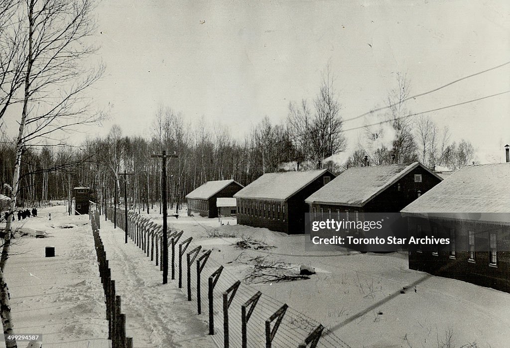 Nestled in snow; Double wire fencing features the camp-like atmosphere of the internment centre at P...