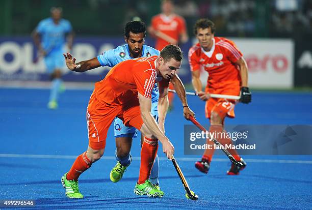 Glenn Schuurman of Netherlands vies with Dharamvir Singh of India during the match between Netherlands and India on day four of The Hero Hockey...