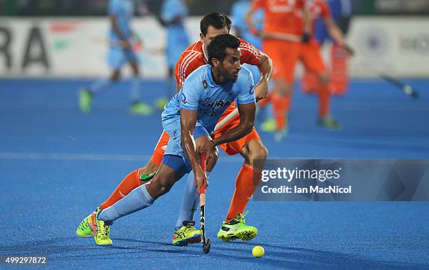 Dharamvir Singh of India runs with the ball during the match between Netherlands and India on day four of The Hero Hockey League World Final at the...