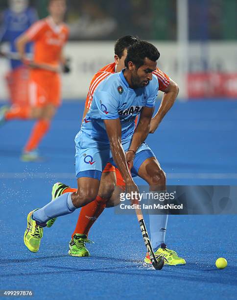 Dharamvir Singh of India runs with the ball during the match between Netherlands and India on day four of The Hero Hockey League World Final at the...