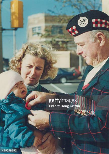 Battle cry: One-year Danielle Roscoe wails - over show photography; not a pinprick - as 48th Highlander veteran William Whaites; who fought in Sicily...