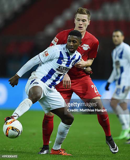 Barry Boubacar of Karlsruhe and Marcel Halstenberg of RB Leipzig compete for the ball during the Second Bundesliga match between Karlsruher SC and RB...