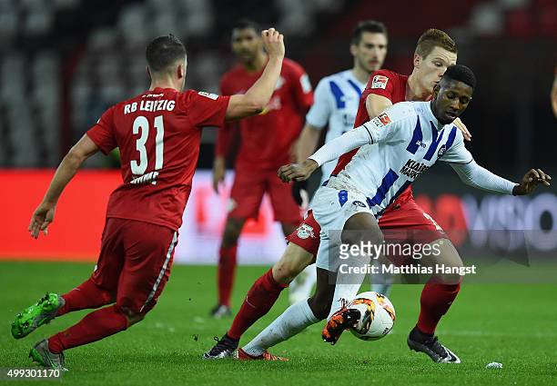 Barry Boubacar of Karlsruhe is challenged by Diego Demme of RB Leipzig and Marcel Halstenberg of RB Leipzig during the Second Bundesliga match...