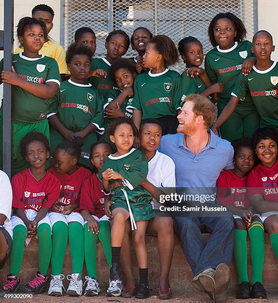 Prince Harry poses with children at Football For Hope Centre in Khayelistsha during an official visit to Africa on November 30, 2015 in Cape Town,...