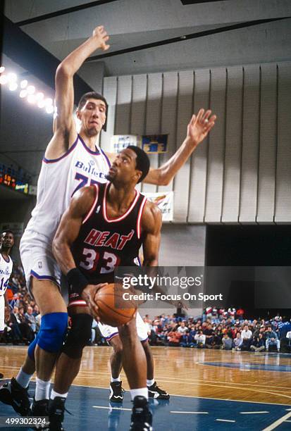 Alonzo Mourning of the Miami Heat looks to get his shot off over Gheorghe Muresan of the Washington Bullets during an NBA basketball game circa 1995....