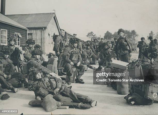 Canadian Paratroopers in full battle order are grouped on the unit's parade square in England; prior to moving on to the concentration area for the...