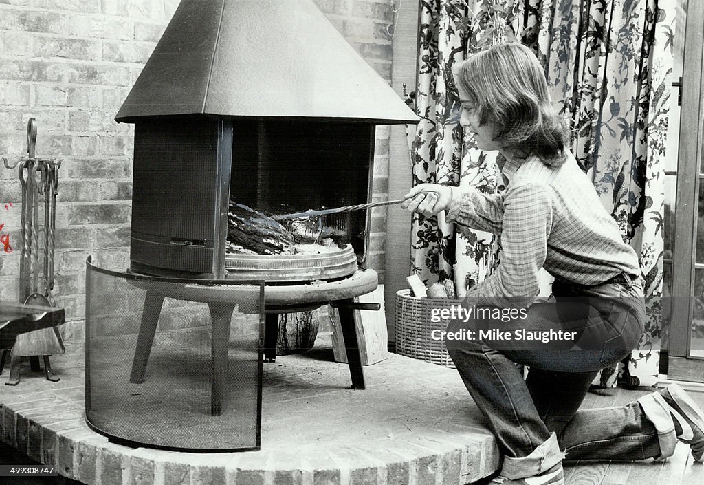 Money saver: Kathleen Ratchford; fifteen; tends fire in the family's Jotul cast-iron woodstove.