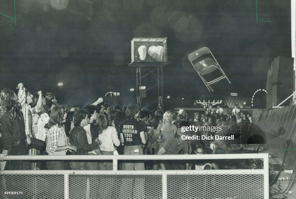 Chair Riots Rock fans close to the Grandstand stage cheer as chair flies through ...