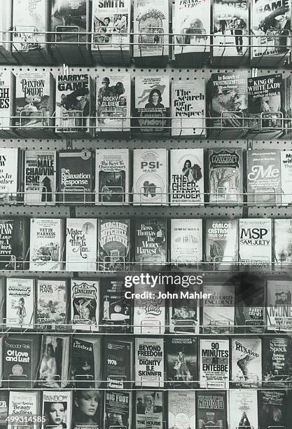 American books monopolize paperback racks in stores; says author Richard Rohmer.