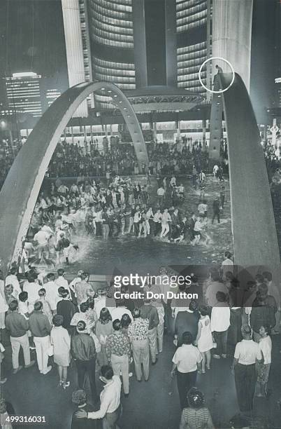 Snake dance swingers wind their way through the pool in front of new City Hall as the Centennial revelry reached its heigt last night. And talking of...