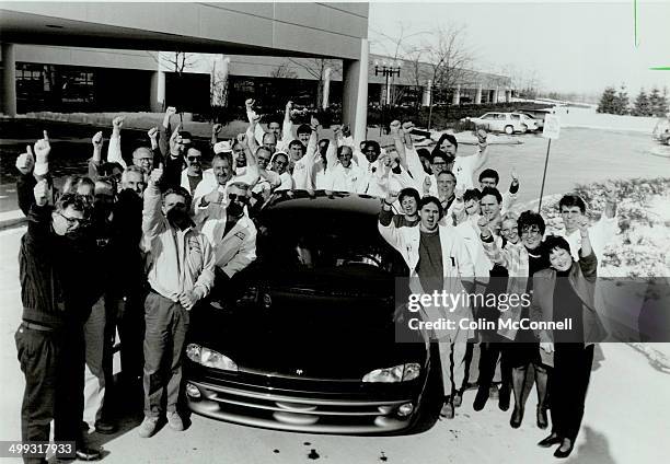Thumbs' up favorite: Showing off one sedan - the Chrysler intrepid - in its Car of the Year lineup yesterday are representatives from every area of...