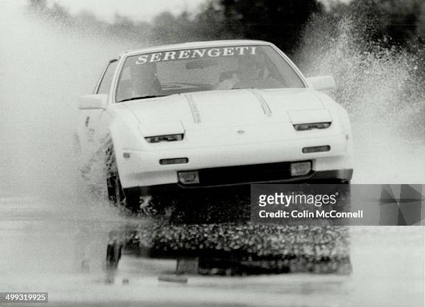 Wet school: Nissan 300 ZX scrambles for traction on wet slalom course at Shannonville. Student driver Carola Vyhnak prepares for skid pad.