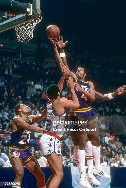 Adrian Dantley of the Utah Jazz looks to shoot over Greg Ballard of the Washington Bullets during an NBA basketball game circa 1980 at the Capital...