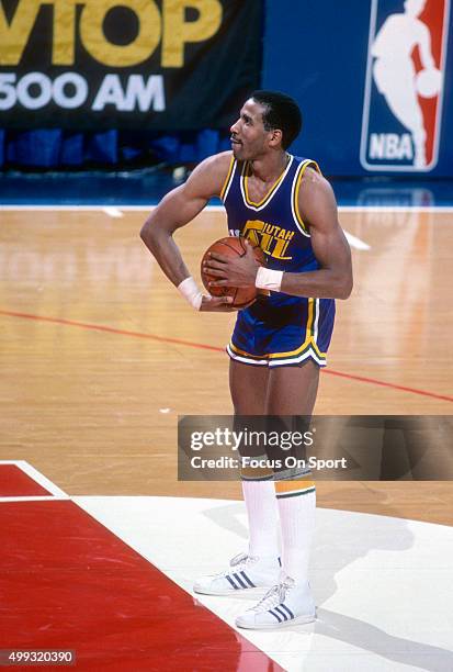 Adrian Dantley of the Utah Jazz stands at the line to shoot a free throw against the Washington Bullets during an NBA basketball game circa 1984 at...