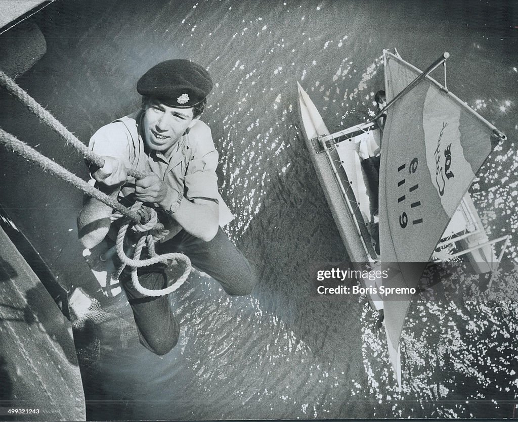 Using a bosun's chair; Sea Cadet David Eadie goes over the side of the destroyer HMCS Haida; moored ...