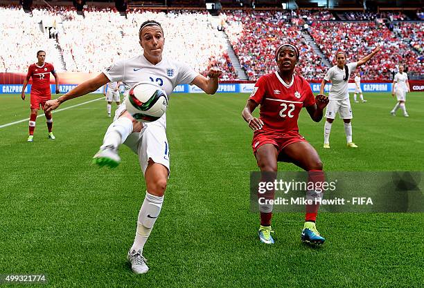 Lucy Bronze of England clears under pressure from Ashley Lawrence of Canada during the FIFA Women's World Cup 2015 Quarter Final match between...