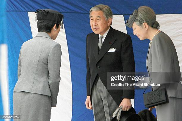 Emperor Akihito and Empress Michiko talk with Princess Hisako of Takamado during their visit to the grave of late Prince Takamado at Toshimagaoka...