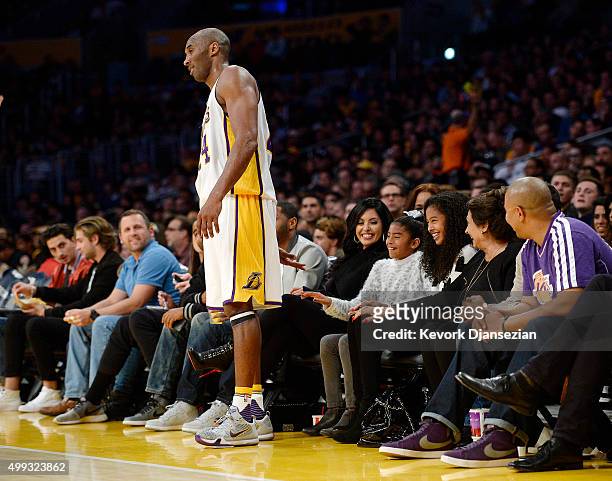 Kobe Bryant of the Los Angeles Lakers asks for a low five from his youngest daughters Gianna as sister Natalia and wife Vanessa looks on during the...