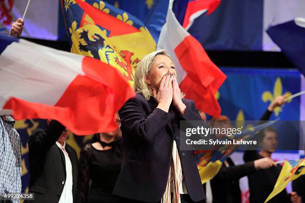 Marine Le Pen, leader of the French far-right National Front party, waves to supporters during her campaign rally for the upcoming regional elections...