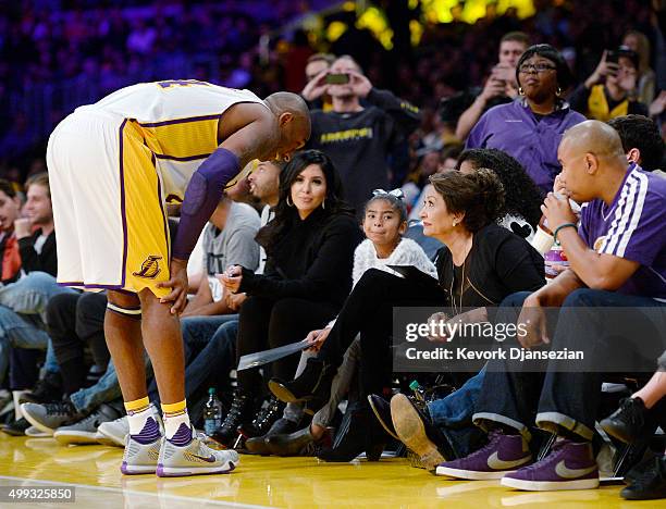 Kobe Bryant of the Los Angeles Lakers talks with a family member as wife Vanessa Laine Bryant , and daughters Gianna Bryant and Natalia Bryant look...