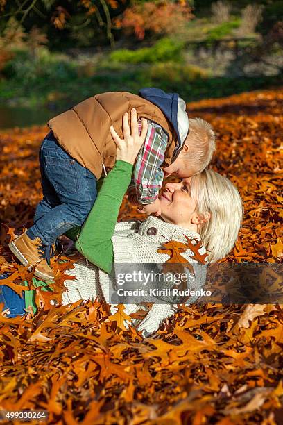 playful mother with her son - woman and child in forest stock pictures, royalty-free photos & images