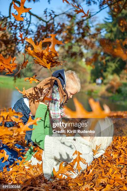 playful mother with her son - woman and child in forest stock pictures, royalty-free photos & images