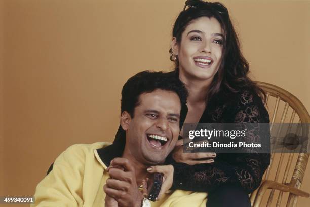 Portrait of Indian film actor Manoj Bajpai and actress Raveena Tandon.