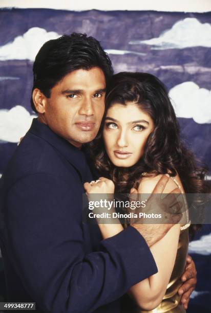 Portrait of Indian film actor Sunil Shetty and actress Raveena Tandon.