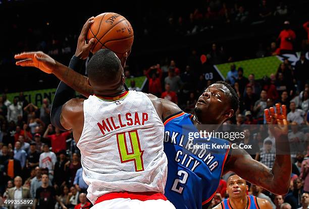 Anthony Morrow of the Oklahoma City Thunder fouls Paul Millsap of the Atlanta Hawks at Philips Arena on November 30, 2015 in Atlanta, Georgia. NOTE...