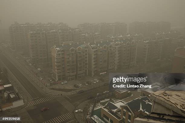 Heavy haze surrounds the a residence community on December 1, 2015 in Beijing, China. China's capital and many cities in the northern part of the...