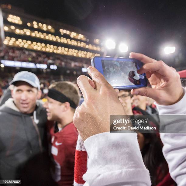 Fan takes a photography of Ed McCaffrey and his son Christian McCaffrey of the Stanford Cardinal following an NCAA football game against the Notre...