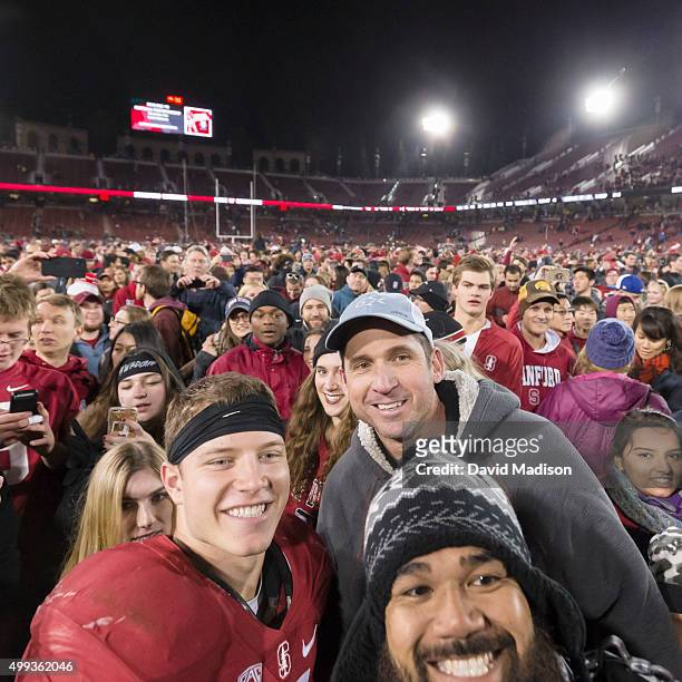 Christian McCaffrey of the Stanford Cardinal and his father Ed McCaffrey , a former Stanford and NFL wide receiver, pose for a fan photo following an...