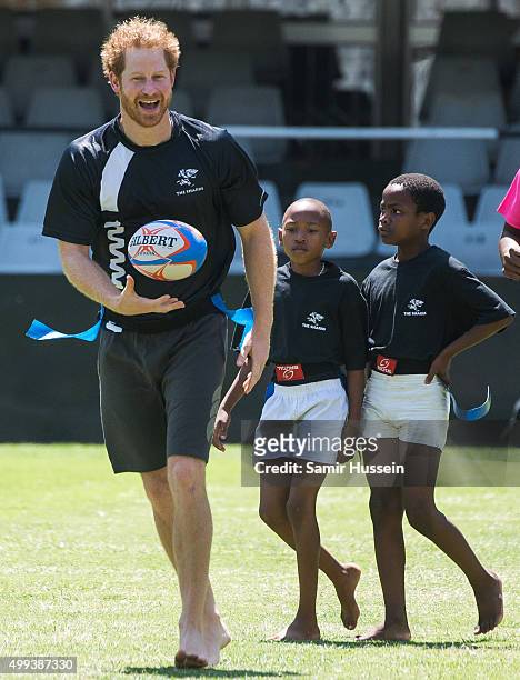 Prince Harry takes part in a rugby game with children at The Sharks rugby club at Kings Park Park Stadium during an official visit to Africa on...