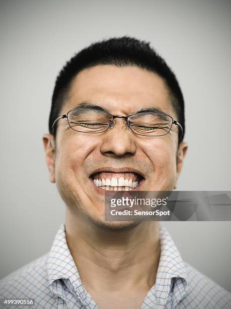 portrait of a happy young japanese man looking at camera - happy face glasses stockfoto's en -beelden