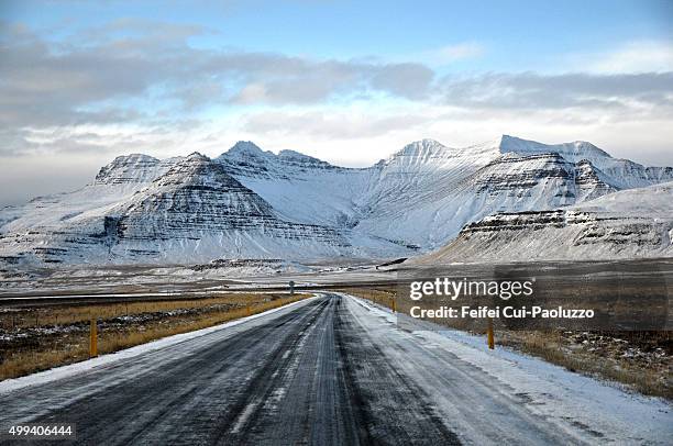 snowy covered road to stykkisholmur west iceland - slippery road sign stock pictures, royalty-free photos & images