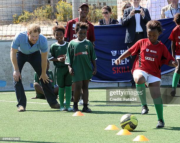 Prince Harry plays soccer with a group of children at the Khayelitsha Football for Hope Centre on November 30, 2015 at in Cape Town, South Africa....