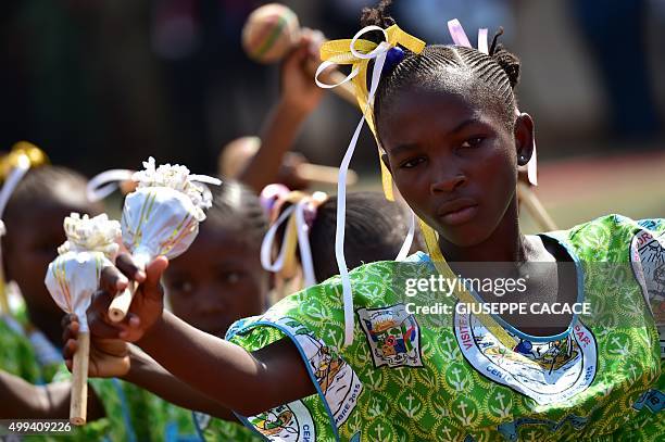 Girl dances at the Bangui Stadium where Pope Francis leads a mass on November 30, 2015 as part of a papal visit to Africa. Pope Francis arrived as "a...