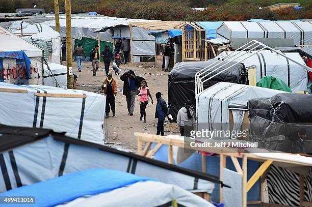Migrants contend with wintery conditions in the camp known as the 'New Jungle' on December 1, 2015 in Calais, France. Thousands of migrants continue...