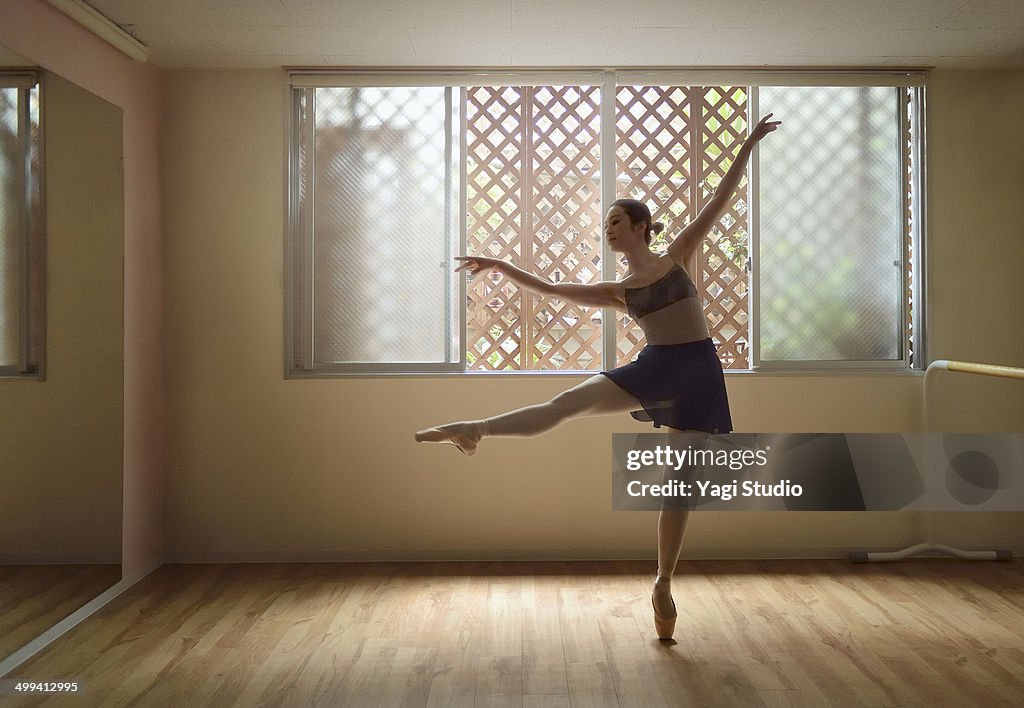 Ballerina exercising in studio