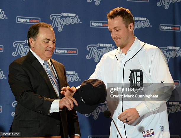 Detroit Tigers Executive Vice President of Baseball Operations and General Manager Al Avila hands a baseball hat to new Tigers pitcher Jordan...