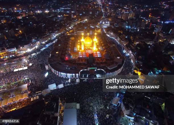 An aerial view taken on December 1, 2015 shows Iraqi Shiite pilgrims gathering at the shrine of Imam Abbas ibn Ali, the brother of Imam Hussein,...